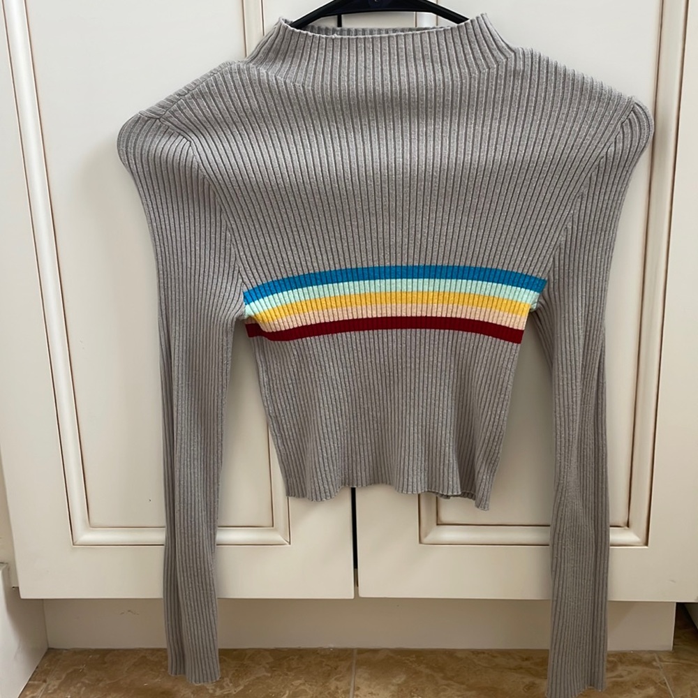 Grey Turtleneck shirt with colored stripe design in the middle.